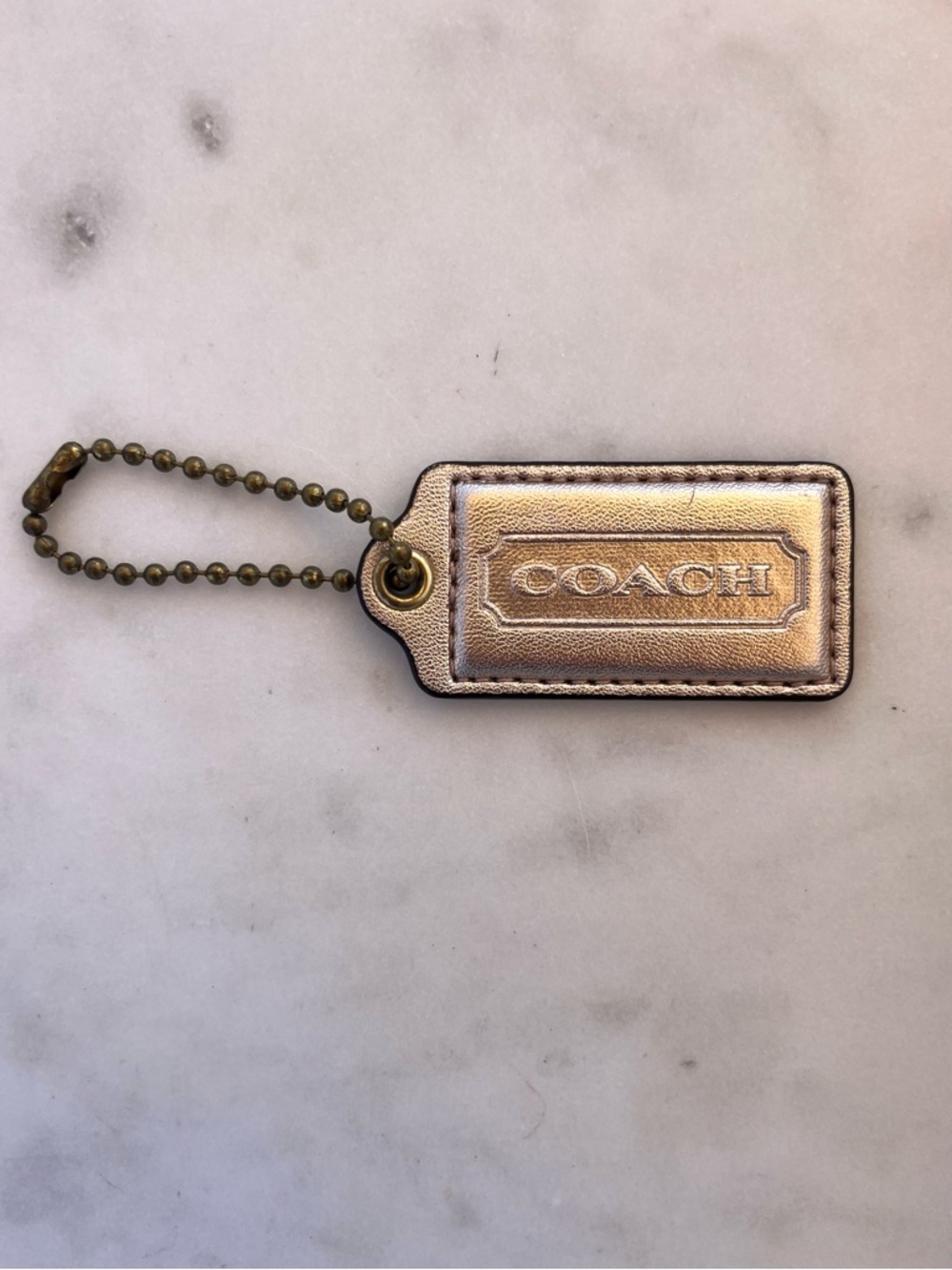 COACH Vintage Metallic Leather Hang Tag, Light Gold